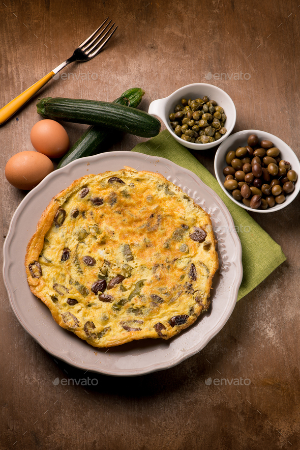 omelette with zucchinis black olives and capers Stock Photo by